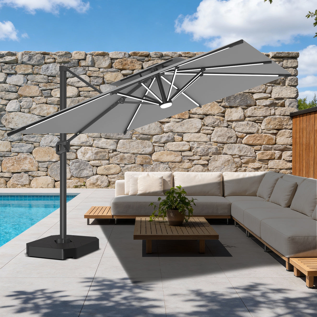 Patioslife grey cantilever parasol with LED lights over outdoor sofa set on stone wall patio