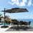 Patioslife black cantilever patio umbrella with LED lights over poolside dining set by the ocean