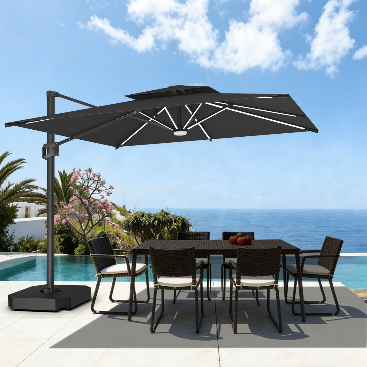 Patioslife black cantilever patio umbrella with LED lights over poolside dining set by the ocean