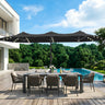 Patioslife black patio umbrella with LED lights over outdoor dining set beside pool and garden