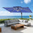 Patioslife navy blue cantilever parasol with LED lights shading outdoor sofa by sea view patio