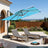 Patioslife turquoise cantilever parasol with LED lights over sun loungers on garden patio